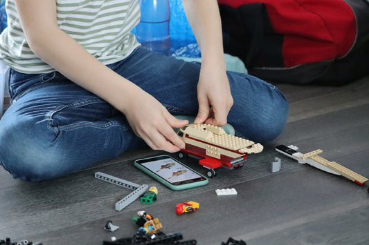 a boy is playing building blocks