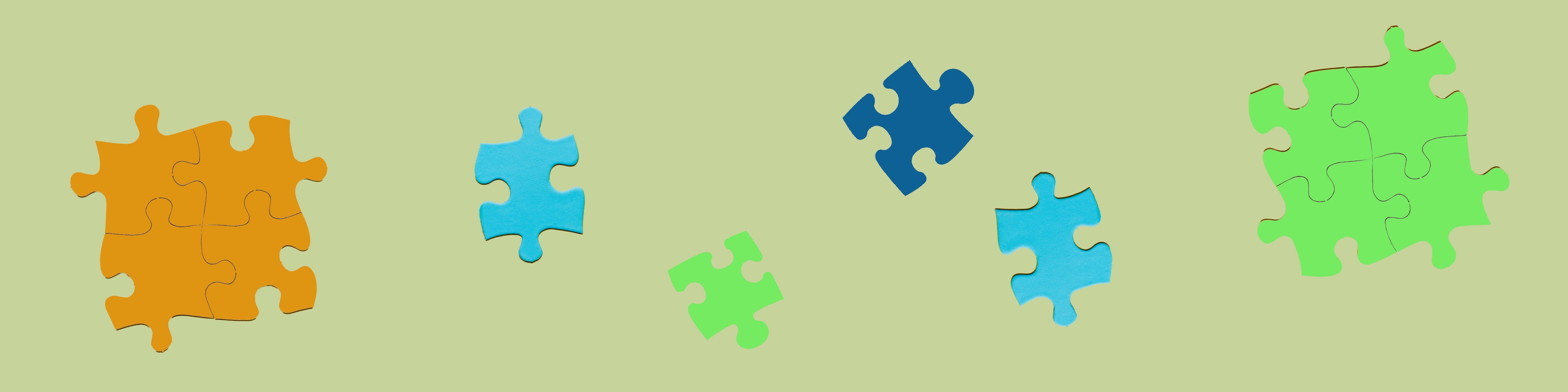 A vibrant collection of puzzle pieces arranged on a green background, showcasing a 2D puzzle banner design